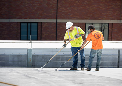 Workers applying AlphaGuard BIO Base Coat